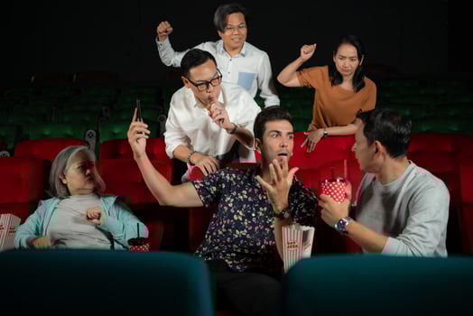 Movie etiquette, Do not talk on the phone while in the cinema, Group recreation and entertainment concept. photo