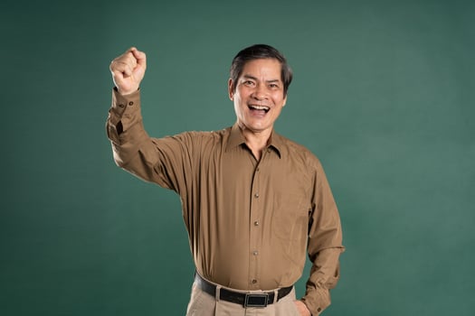 portrait of middle aged asian man posing on blue background photo