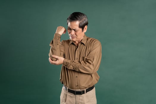portrait of middle aged asian man posing on blue background photo