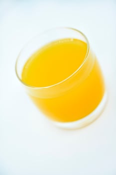 Glass glasses with orange juice on a white background. Delicious orange cooling drink. photo