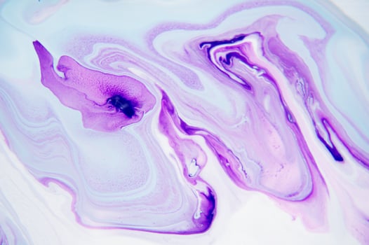 Abstract created using the technique of liquid acrylic. Macro photography of the smallest details of a panting. The panting shows how overflows of shades and colors of paint resemble space motifs. photo