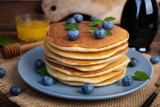 Delicious pancakes with blueberries and honey. Sweet pancakes with fresh berries photo