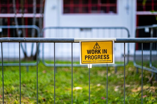 Yellow Work in progress sign billboard panel outdoor under construction board photo