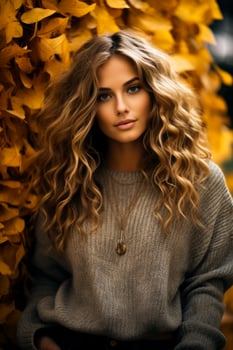 A woman in a cozy oversized sweater poses among fallen leaves showcasing the perfect blend of style and nature photo