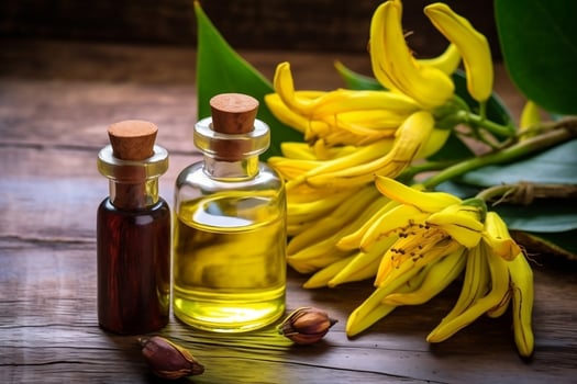 ylang ylang or cananga odorata flower essential oil alongside ylang ylang or cananga odorata flower on a table photo