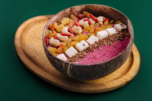 Healthy breakfast raisins and cashew nuts smoothie in coconut bowl photo