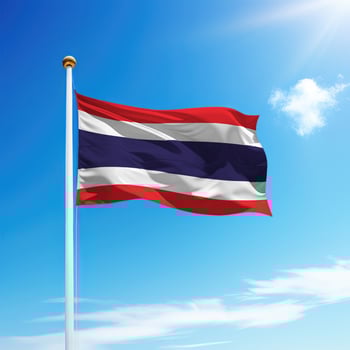 Waving flag of Thailand on flagpole with sky background. photo