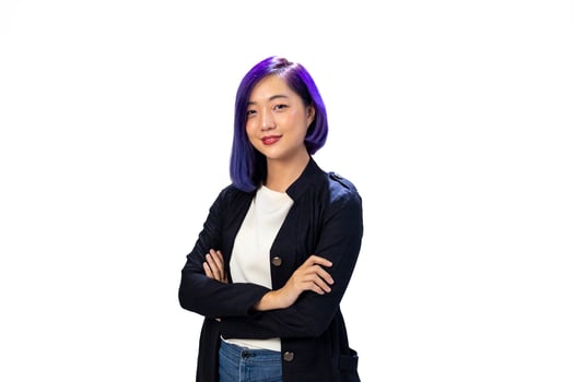 Portrait of young smart businesswoman in formal cloth with dyed blue hair cross hand isolated on white background for business people usage photo