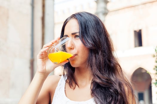 portrait of attractive girl while drinking an orange juice photo