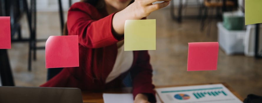 Asian Businesswoman Using laptop computer and working at office with calculator document on desk, doing planning analyzing the financial report, business plan investment, finance analysis concept. photo