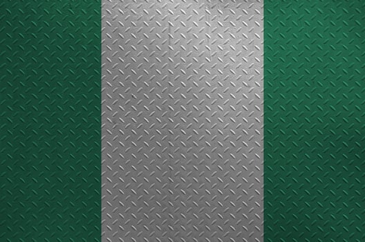 Nigeria flag depicted in paint colors on old brushed metal plate or wall closeup. Textured banner on rough background photo