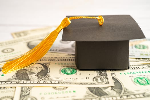 Graduation gap hat on Euro and US dollar banknotes money, Education study fee learning teach concept. photo