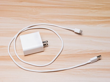 USB charger and cable type-C white color on wood table photo