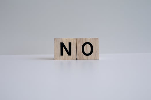 Wooden blocks form the text NO against a white background. photo