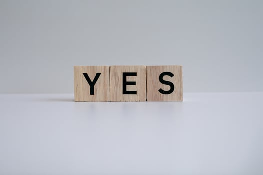 Wooden blocks form the text YES against a white background. photo