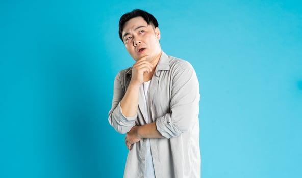 Portrait of an Asian guy posing on a blue background photo