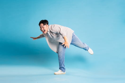 Full body image of Asian man posing on blue background photo