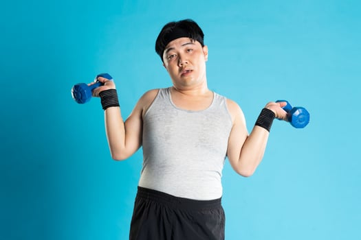Image of Asian man exercising on blue background photo