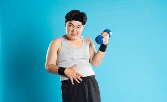 Image of Asian man exercising on blue background photo