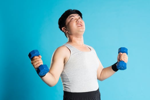 Image of Asian man exercising on blue background photo