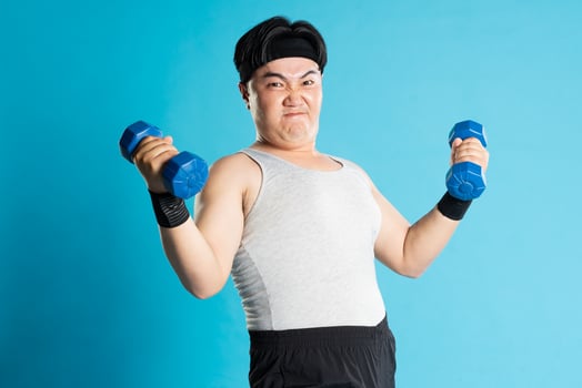 Image of Asian man exercising on blue background photo