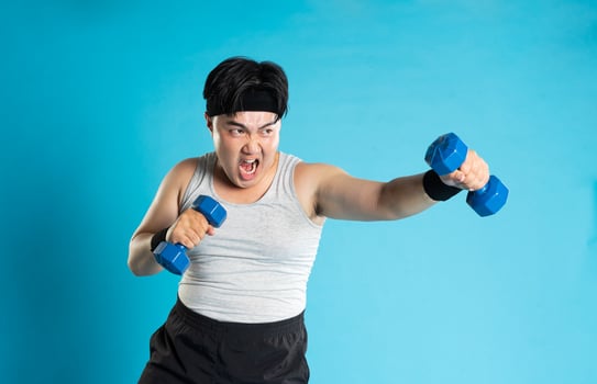 Image of Asian man exercising on blue background photo