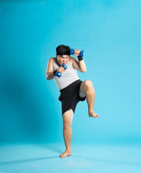 Image of Asian man exercising on blue background photo