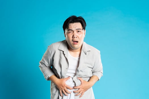 Image of Asian man having health problems, isolated on blue background photo