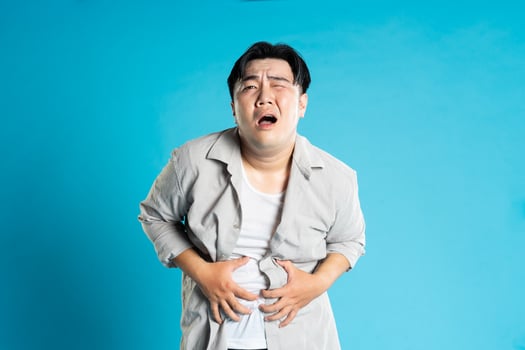 Image of Asian man having health problems, isolated on blue background photo