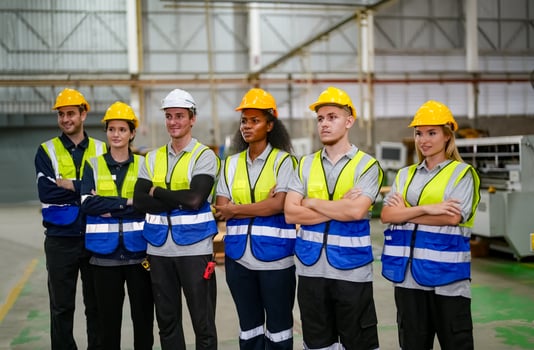 Group of workers standing in factory photo
