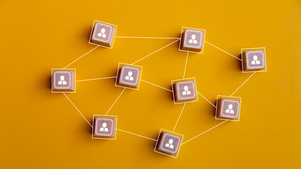 Wooden blocks connected together on a yellow background. Teamwork, network, and community concept. photo