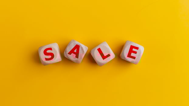 Word SALE on wooden cubes on yellow background. Top view. Price discount, promotion announcement, and shopping concept. photo
