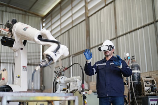 A man wearing a vr headset and holding a robot photo