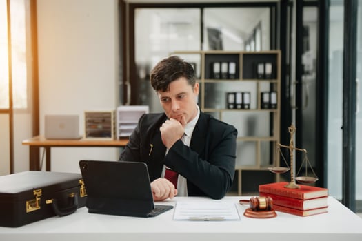 Man lawyer working and gavel, tablet, laptop in front, Advice justice and law concept. photo