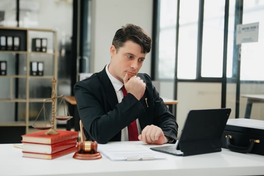 Man lawyer working and gavel, tablet, laptop in front, Advice justice and law concept. photo