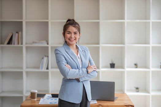 Confident Asian businesswoman standing in office, looking at camera with professional demeanor. modern asian business professional. photo