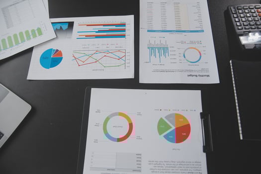 Financial analysts analyze business financial reports on a digital tablet planning investment project during a discussion at a meeting of corporate showing the results of their successful teamwork. photo