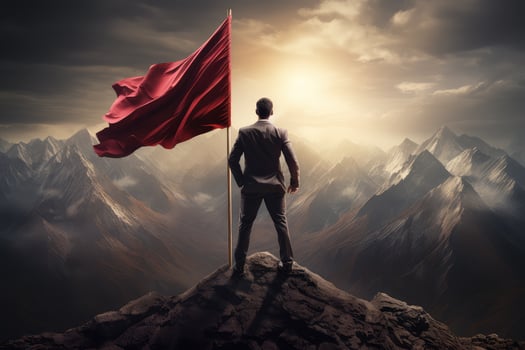 Business success and goal concept with a silhouette of a successful businessman standing with a large flag on top of a mountain in the morning sunlight, featuring his success. AI Generated photo