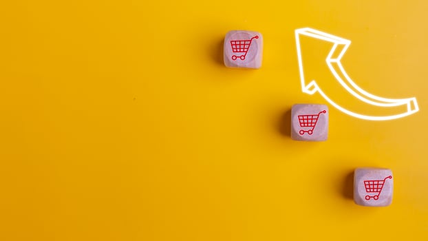 Wooden cubes with shopping cart icons and increasing trend-up graph. Increase higher sale volume and shopping trolley cart for online e-commerce business and internet marketing strategy concept. photo