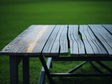 Wooden table and blur tropical green grass background, product display montage. High quality photo 8k FHD AI generated