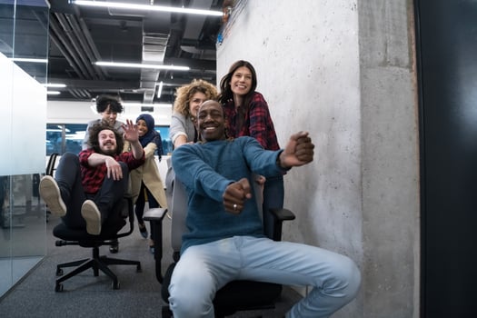 multiethnics business team racing on office chairs photo