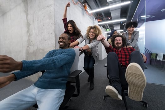 multiethnics business team racing on office chairs photo
