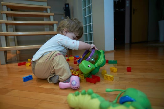 Adorable cute beautiful little baby girl playing with toys at home photo