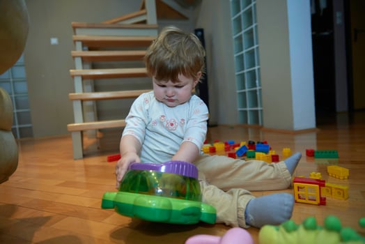 Adorable cute beautiful little baby girl playing with toys at home photo