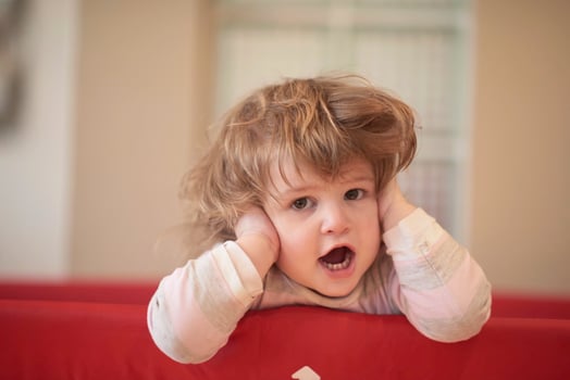 little baby girl with strange hairstyle and curlers photo