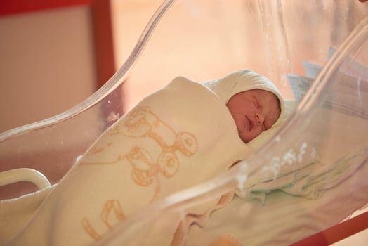 newborn baby sleeping in  bed at hospital photo