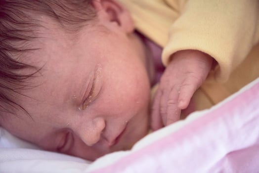 newborn baby sleeping in  bed at hospital photo