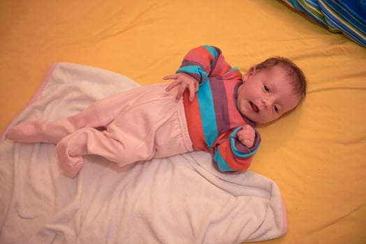 One month newborn baby sleeping  in bed photo