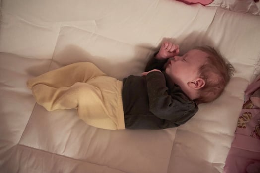 One month newborn baby sleeping  in bed photo