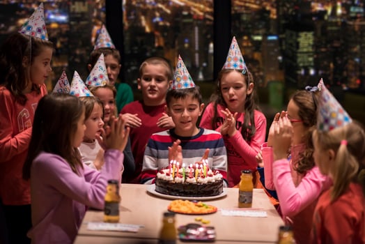 happy young boy having birthday party photo